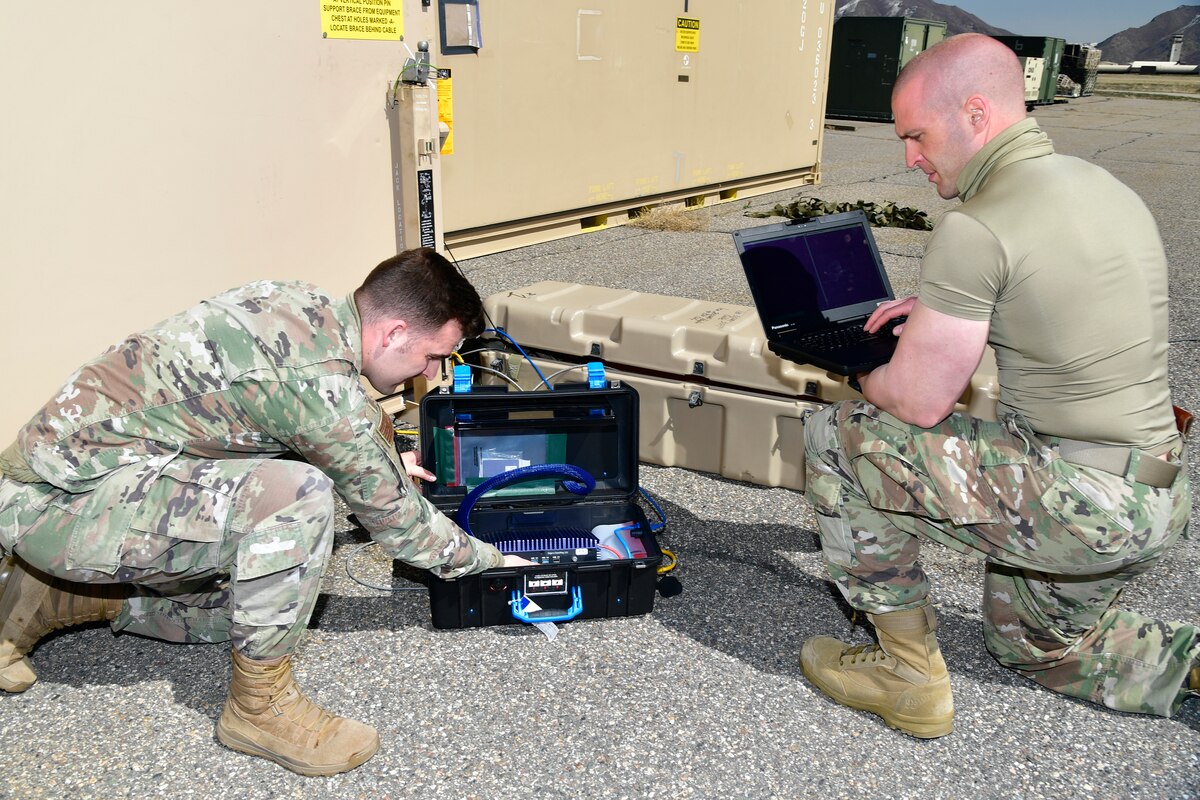 A photo of Airmen setting up communications gear