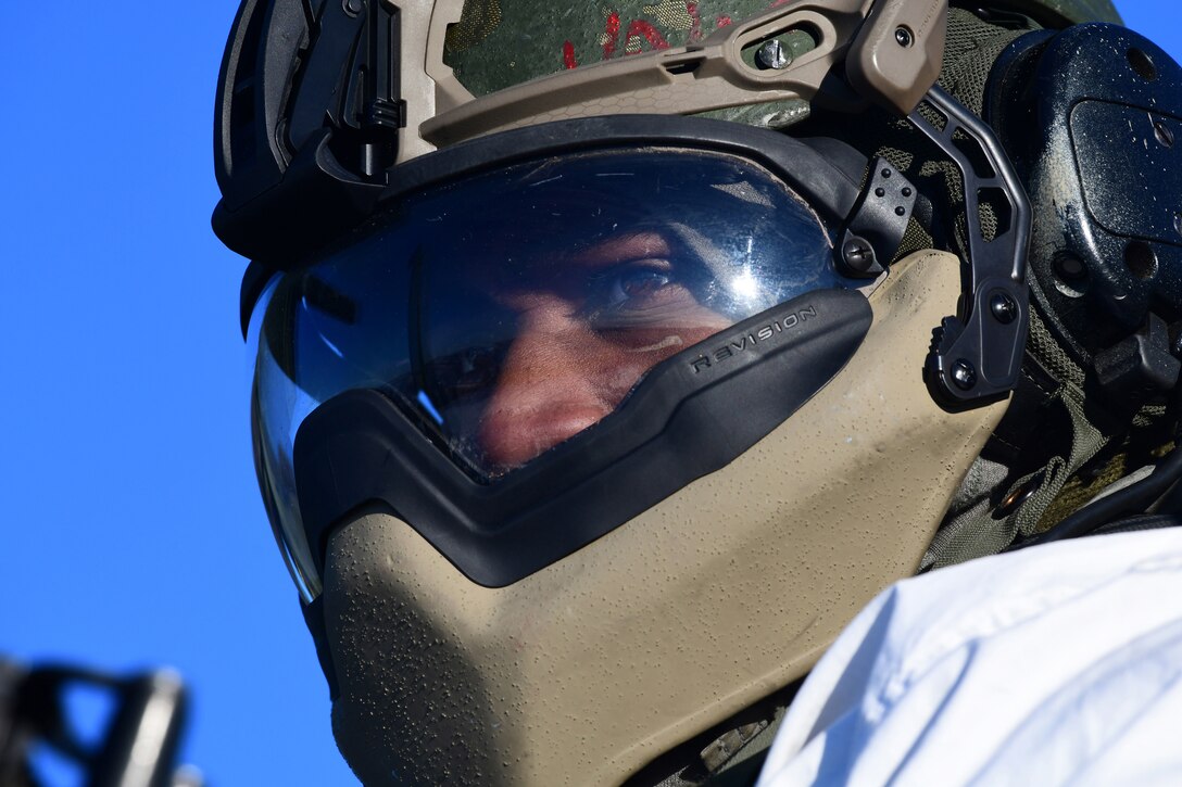 A soldier looks out from a cold weather helmet.