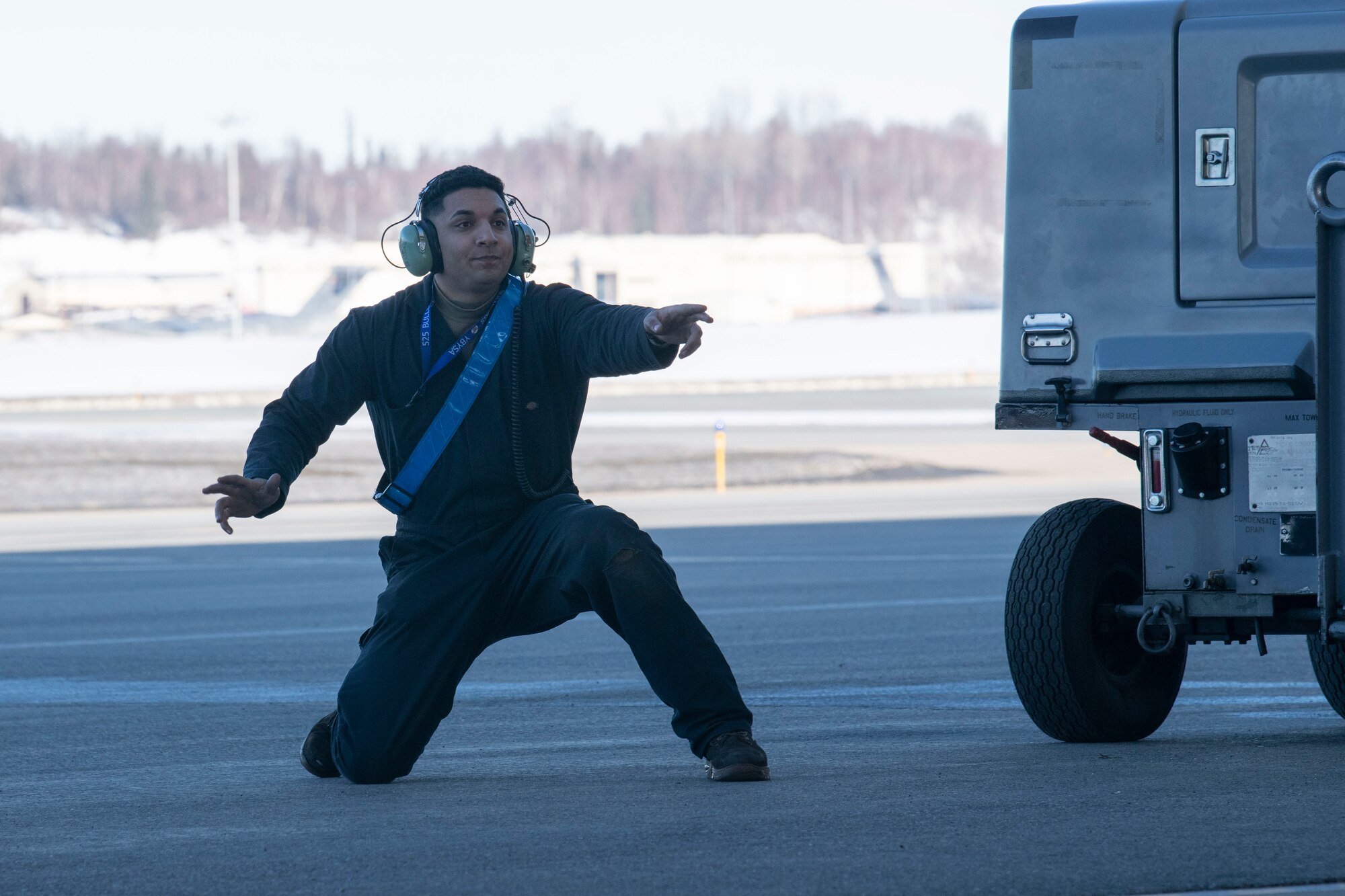 An Airman directs an aircraft on the flightline