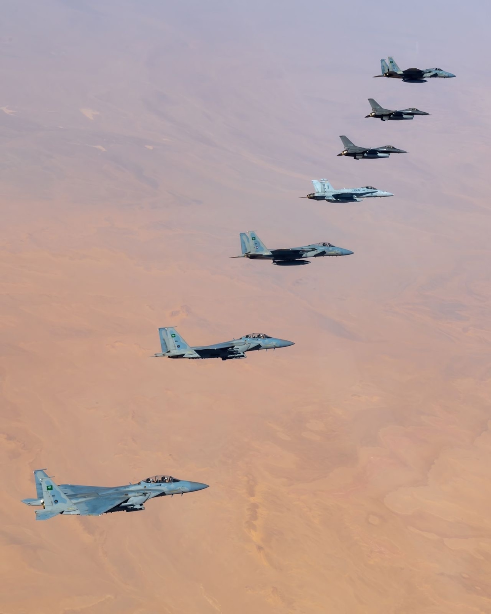 Royal Saudi Air Force F-15s fly alongside U.S. Air Force F-16 Fighting Falcons and a U.S. Marine Corps F/A-18 Hornet during Operation Agile Spartan II. Aircrew conducted Agile Combat Employment concepts throughout the U.S. Central Command area of responsibility during OAS II, which allows flexibility to operate from any location in a contested environment. (Courtesy Photo)