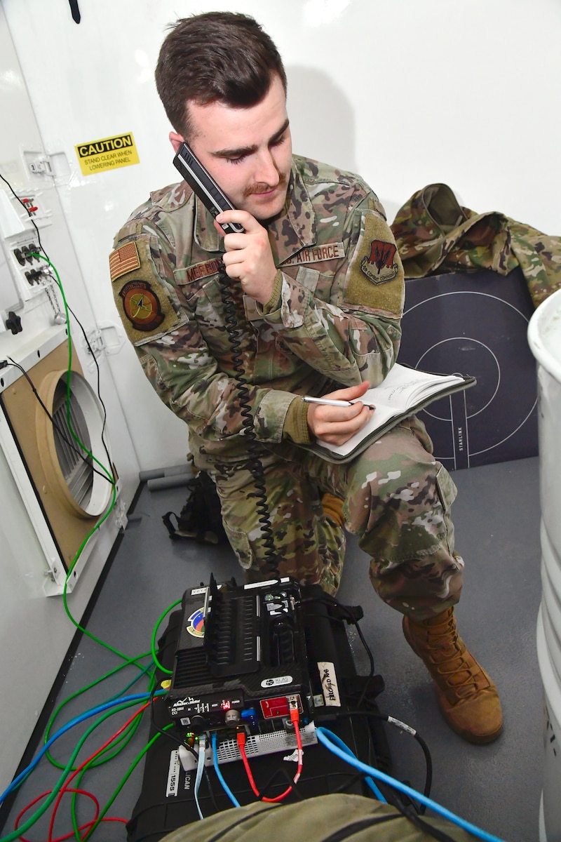 A photo of Airmen setting up communications gear