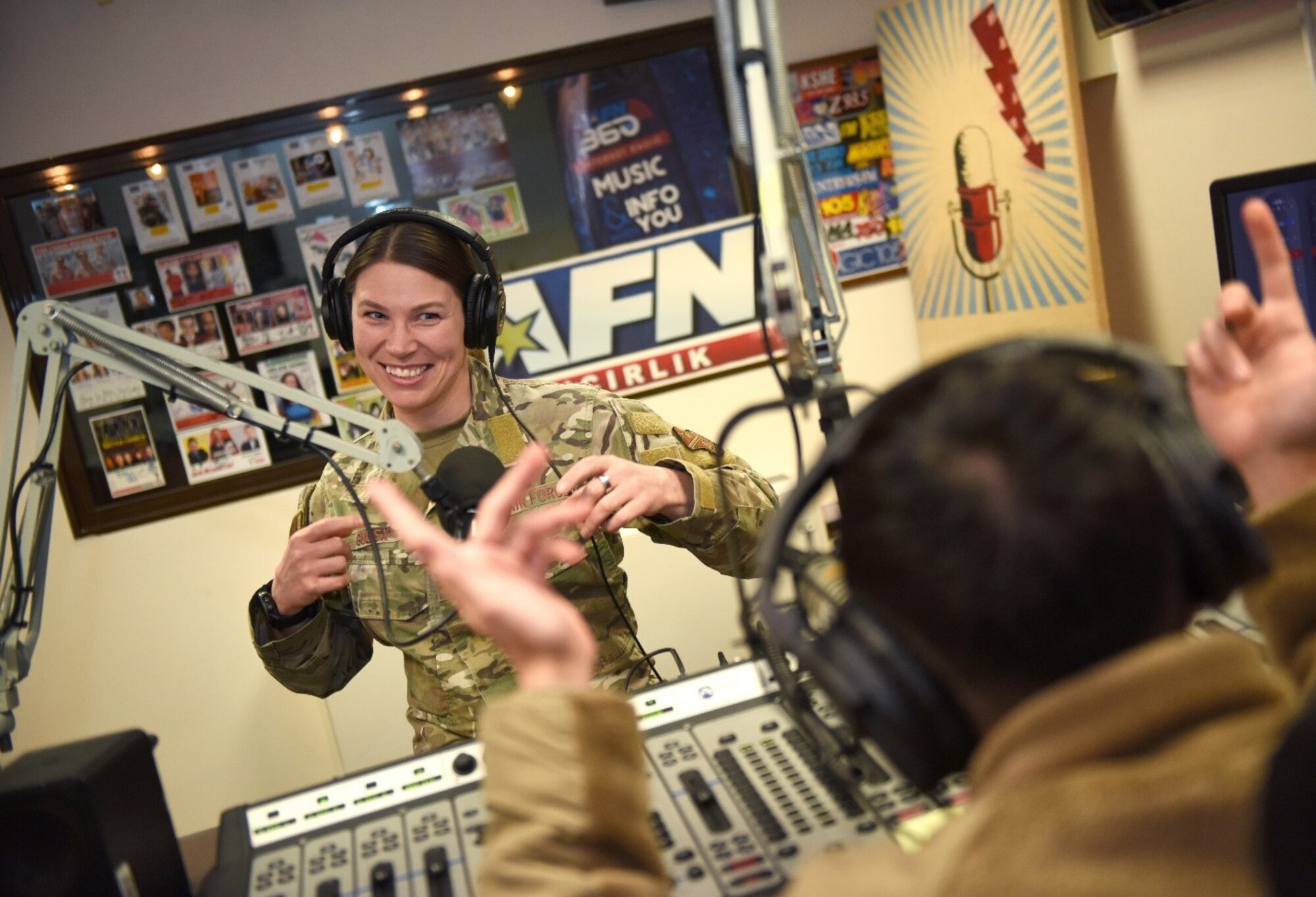 Tech Sgt. Rosemary Gudex, American Forces Network Incirlik operations manager, motivates her troop before he starts his radio show at Incirlik Air Base, Turkey, March 23, 2022. Gudex spent years healing from her experience growing up with an alcoholic father. She now focuses her time and energy on things that hold value to her, like fitness and developing Airmen. (U.S. Air Force photo by Tech. Sgt. Crystal L. Charriere)