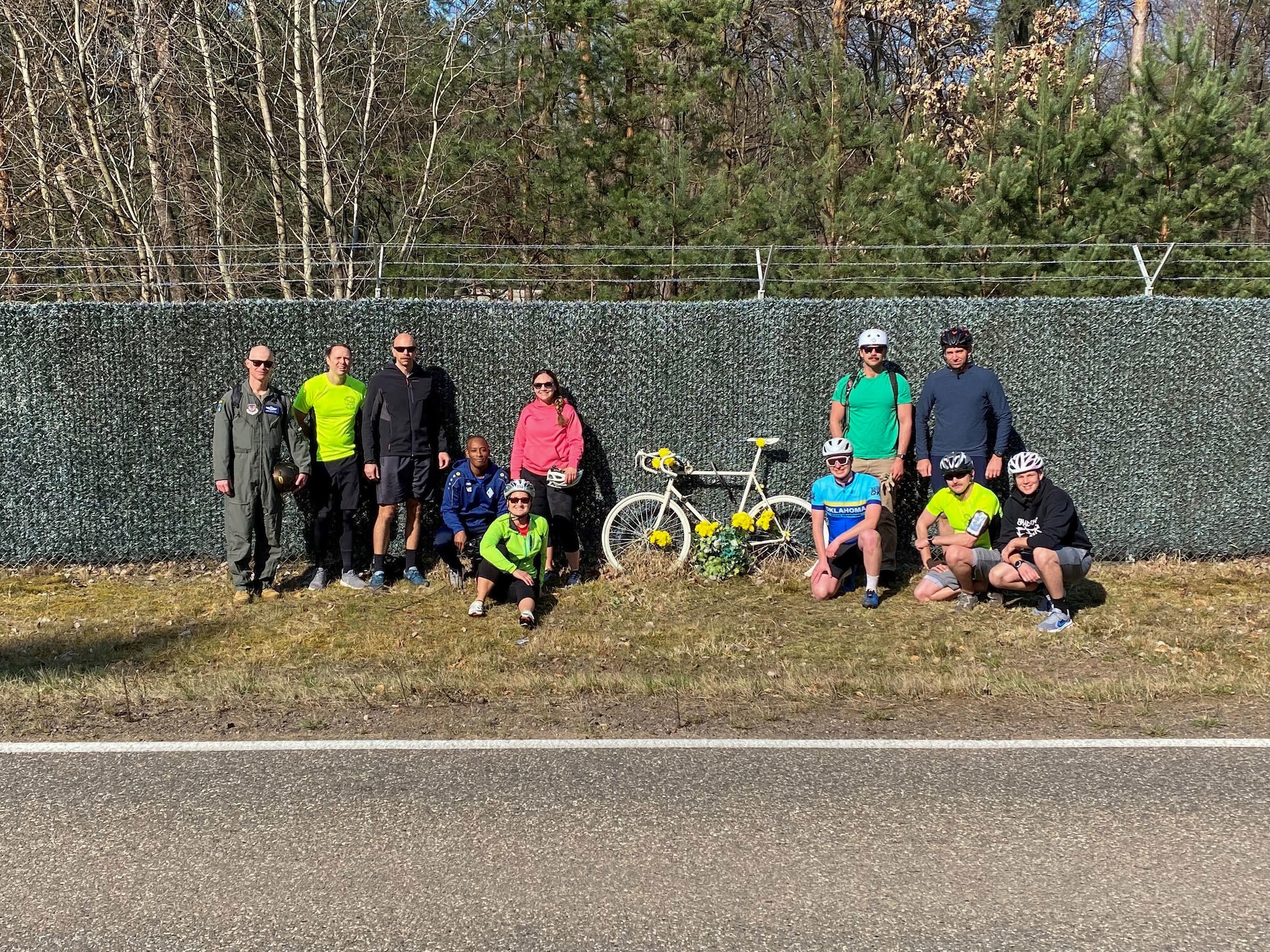 Grant's ride participants stand next to Grant Davis' memorial
