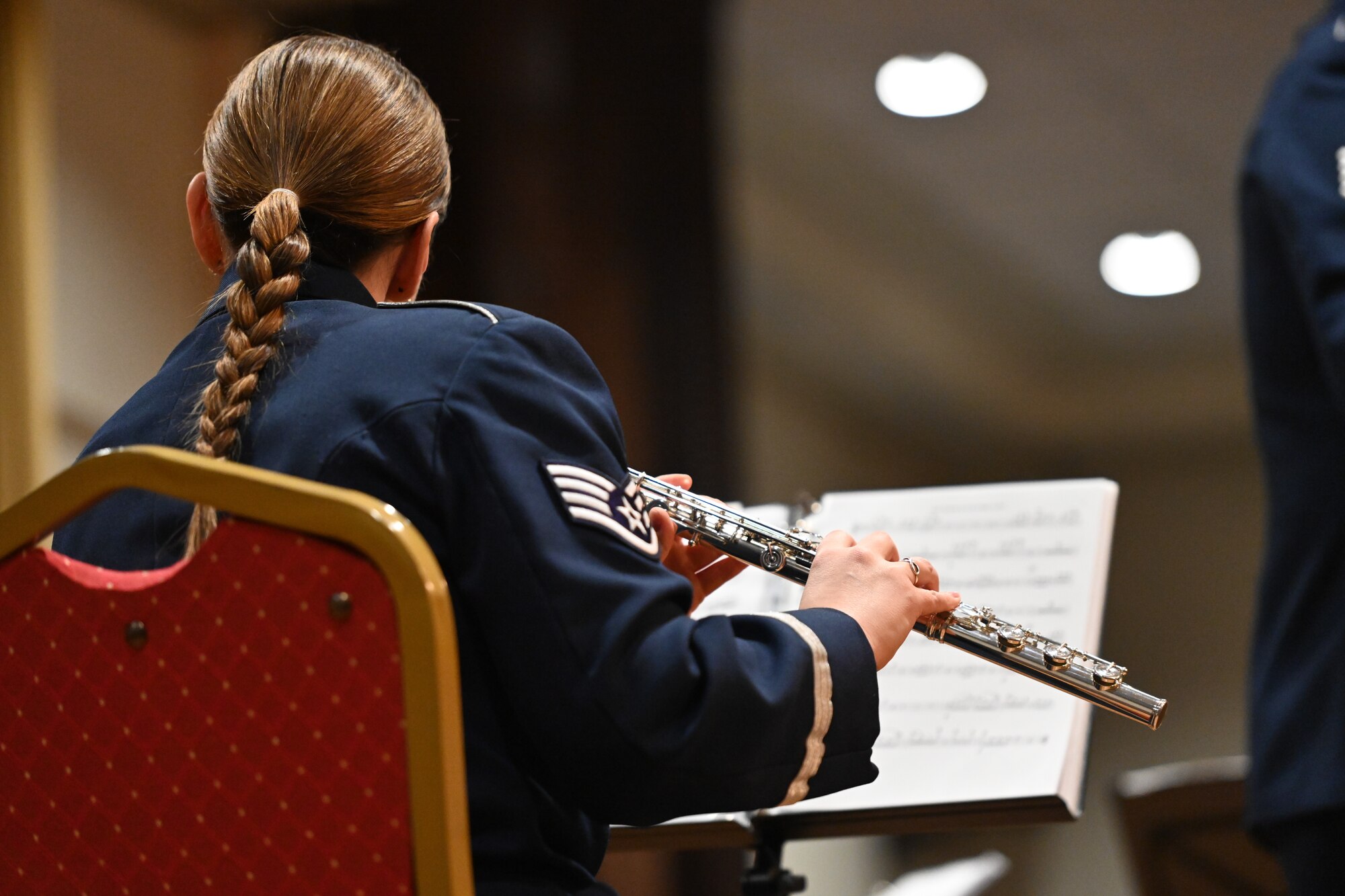 Musician plays the flute.