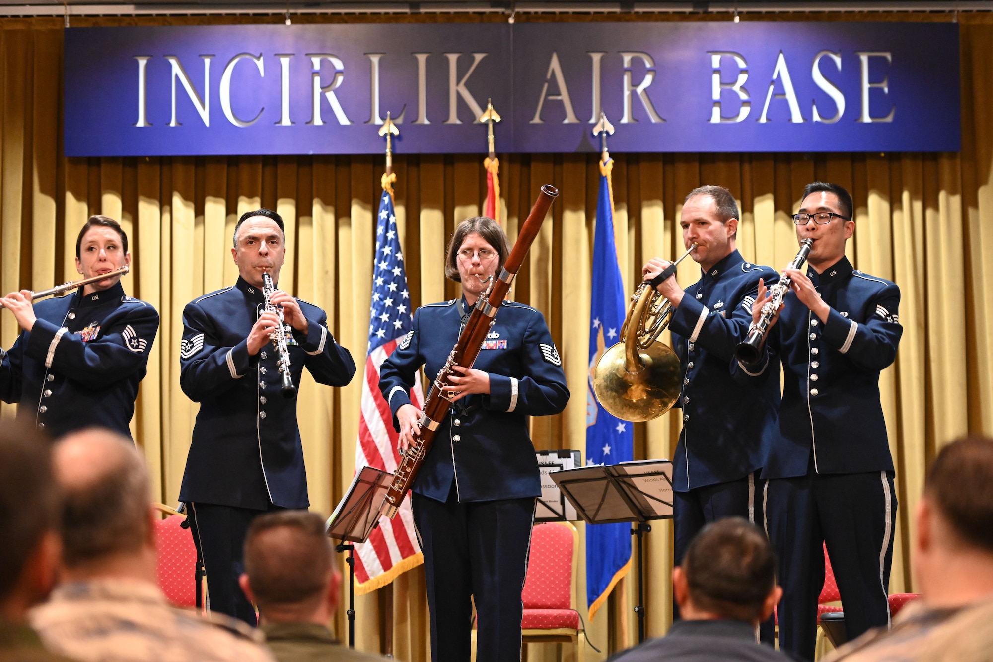 Musicians perform on stage.