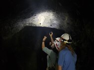 Army Fellows Olivia Finley, Justin Knight, & Nikki Lorvick examine the Granite Foundation underneath Dworshak Dam.