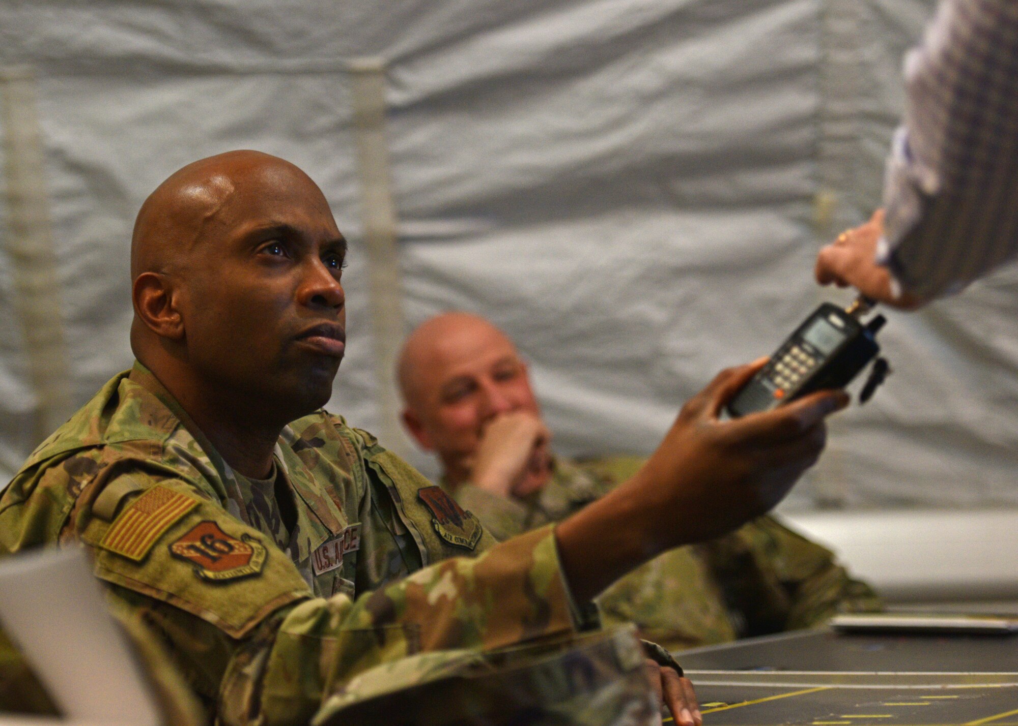 U.S. Air Force Chief Master Sgt. Kenneth M. Bruce Jr., 16th Air Force (Air Forces Cyber) command chief, learns about the Forward Operating Base Sentinel mission at Goodfellow Air Force Base, Texas, March 28, 2022. FOB Sentinel is where the 344th Military Intelligence Battalion students complete their capstone exercise and are able to showcase what they have learned throughout technical training. (U.S. Air Force photo by Senior Airman Ashley Thrash)