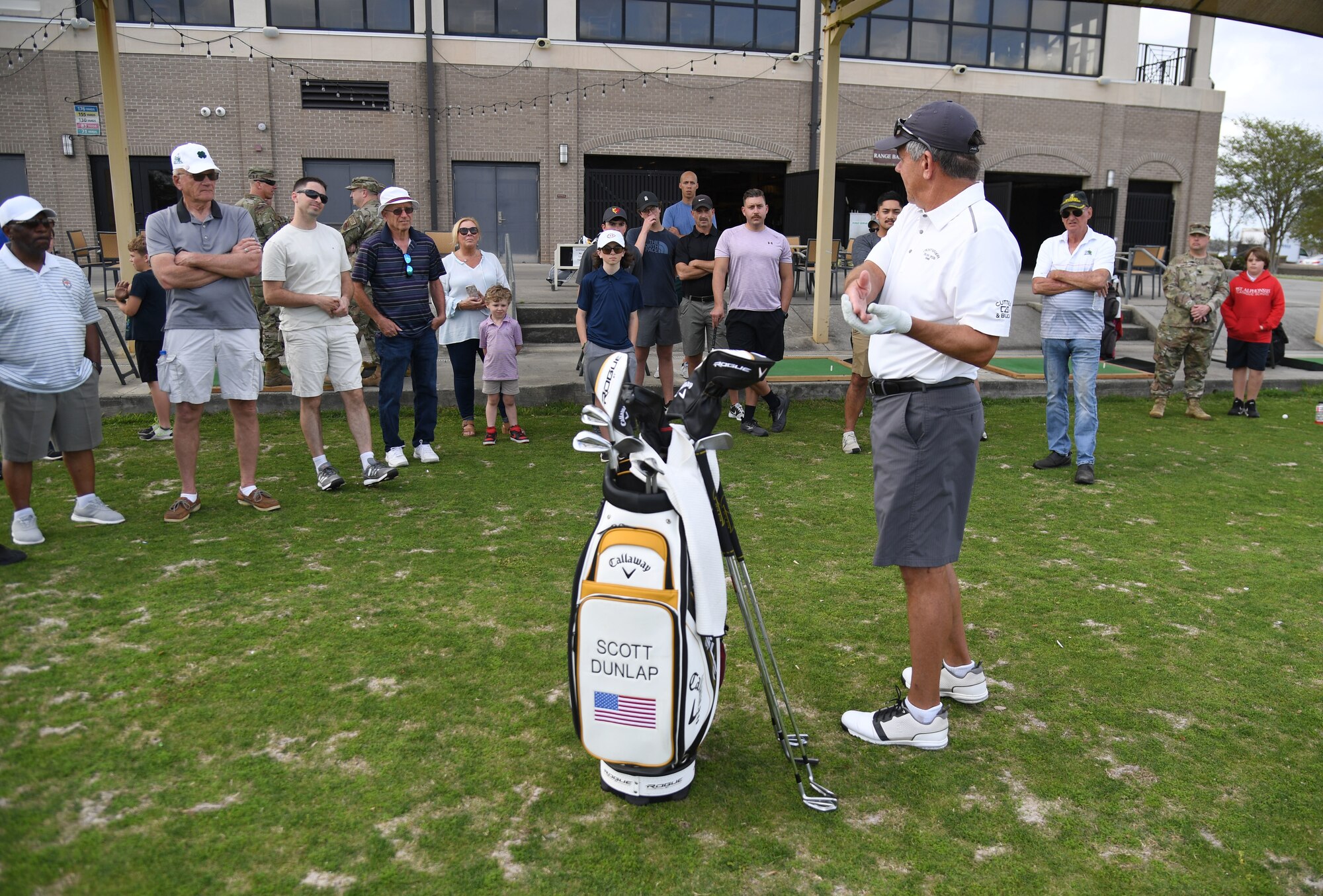 Scott Dunlap, Professional Golfers' Association champion player, provides golfing tips to Keesler personnel during a free clinic at the Bay Breeze Golf Course at Keesler Air Force Base, Mississippi, March 29, 2022. Dunlap is on the coast to compete in the 2022 Rapiscan Systems Classic at Grand Bear Golf Club. (U.S. Air Force photo by Kemberly Groue)