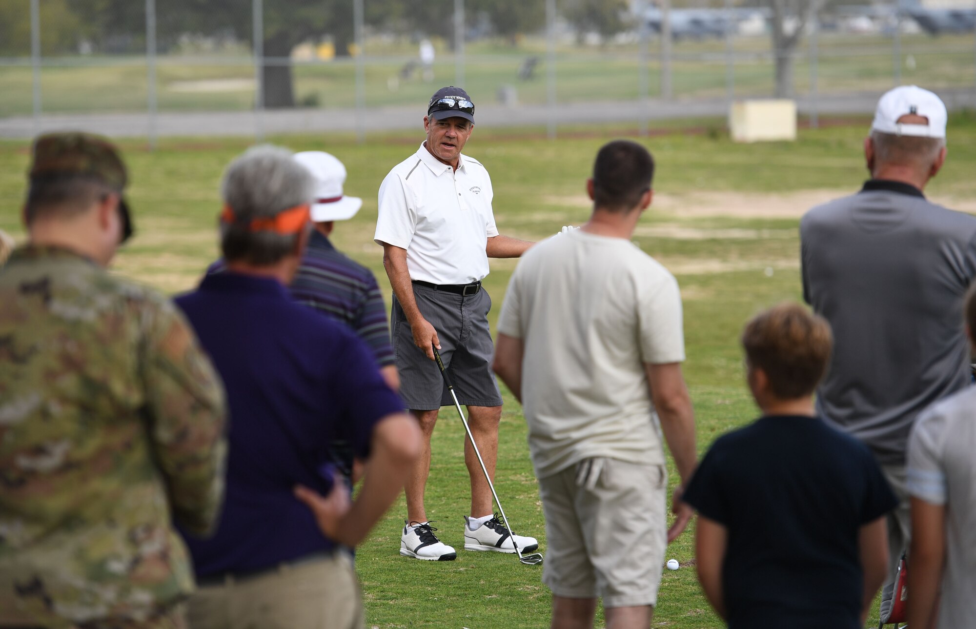 Scott Dunlap, Professional Golfers' Association champion player, provides golfing tips to Keesler personnel during a free clinic at the Bay Breeze Golf Course at Keesler Air Force Base, Mississippi, March 29, 2022. Dunlap is on the coast to compete in the 2022 Rapiscan Systems Classic at Grand Bear Golf Club. (U.S. Air Force photo by Kemberly Groue)