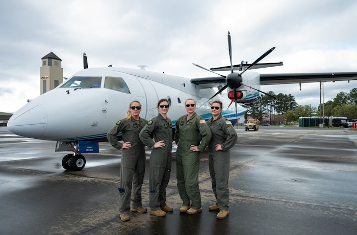 U.S. Air Force Aircrew pose by a C-146A Wolfhound while attending a youth open house event March 12, 2022, at Moody Air Force Base, Georgia.