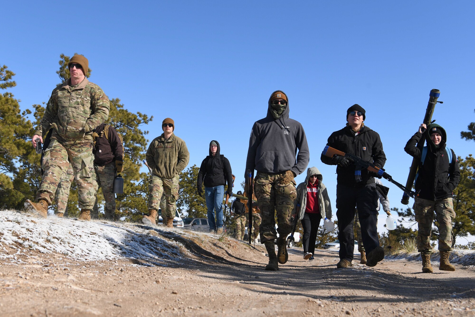 Airmen from the 790th Missile Security Operations Squadron assume the roles of opposing forces and prepare to simulate a payload transporter attack in Pine Bluffs, Wyoming, March 30, 2022. The 90th Security Forces Group conducted full mission profile training to further develop response capabilities to contingency situations during a PT movement. (U.S. Air Force photo by Airman 1st Class Charles Munoz)