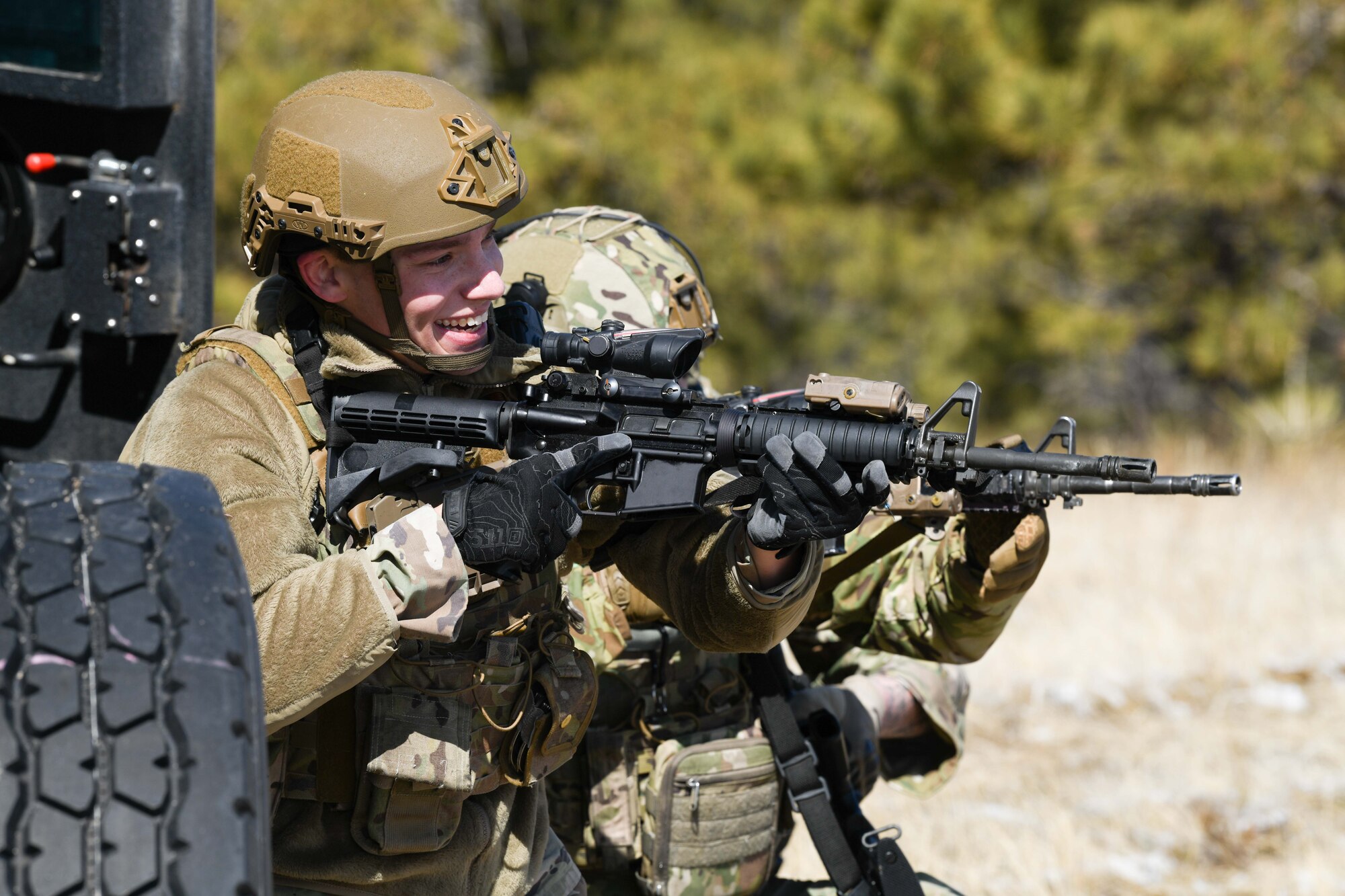 Staff Sgt. Jacob Boyett, convoy response force leader at the 90th Missile Security Operations Squadron, scans a tree line following a simulated payload transporter attack in Pine Bluffs, Wyoming, March 30, 2022. The 90th Security Forces Group conducted full mission profile training to further develop response capabilities to contingency situations during a PT movement. (U.S. Air Force photo by Airman 1st Class Charles Munoz)