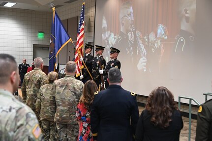 The color guard salutes during the National Anthem at the retirement ceremony for Brig. Gen. Tyler Smith, March 14, 2022.