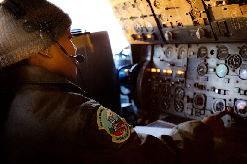 Woman conducts preflight check in cockpit of KC-10