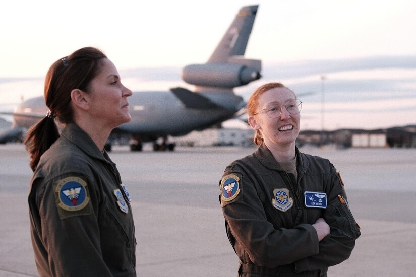 Two women discuss the mission on the flightline
