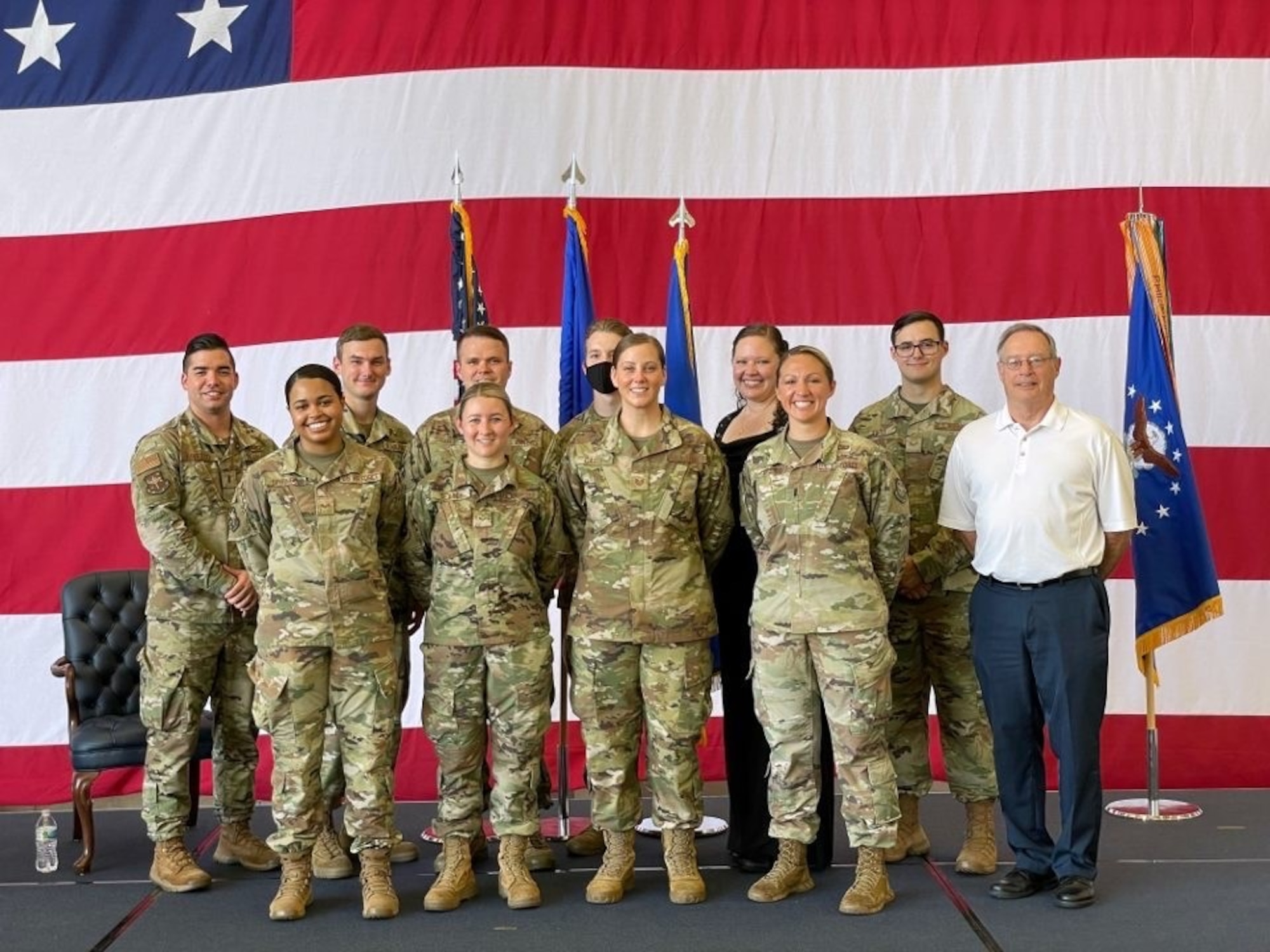 Then 1st Lt. Jessica Cicchetto,19th Airlift Wing chief of public affairs, poses for a photo with her PA team following the 19th AW wing change of command ceremony