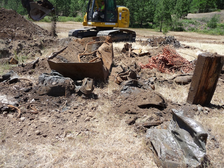 U.S. Army Corps of Engineers technicians confirm the presence of buried waste at Elk Creek Dam, 26 miles north of Medford, after digging test pits, Jun. 18, 2019. The Corps has made several investigations and waste removal efforts at the defunct dam site in the past; however, a 2019 complaint by a former contactor employee to ODEQ shed light on improper disposal by the Obayashi Corporation, the contractor the Corps used during construction.

“While the Corps and the Army Criminal Investigation Division work to hold the responsible party accountable for waste disposed on site, we’re continuing efforts to protect human health and the environment under the Superfund law (Comprehensive Environmental Response, Compensation, and Liability Act (CERCLA))”, said Tom Conning, Portland District spokesmen. “We take environmental protection seriously and will either cleanup the site itself or compel the responsible party to do so.”