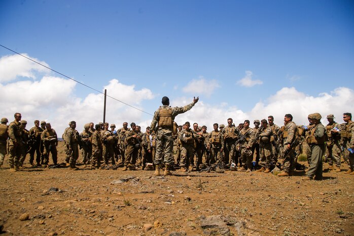 U.S. Marine Corps Staff Sergeant Mikelot A. Edouard, battalion mess chief with 1st Battalion, 12th Marines, 3rd Marine Division, gives a brief prior to teaching foraging techniques during Spartan Fury 22.1 at Pohakuloa Training Area, Hawaii, March 7, 2022. Individual Batteries procured local food and experimented with field cooking methods using lightweight, expeditionary equipment that is sustainable for long durations in austere environments. Spartan Fury is a Battalion level training exercise designed to refine long-range communications through naval asset integration, mission processing from battalion to firing sections, and 21st Century Foraging.