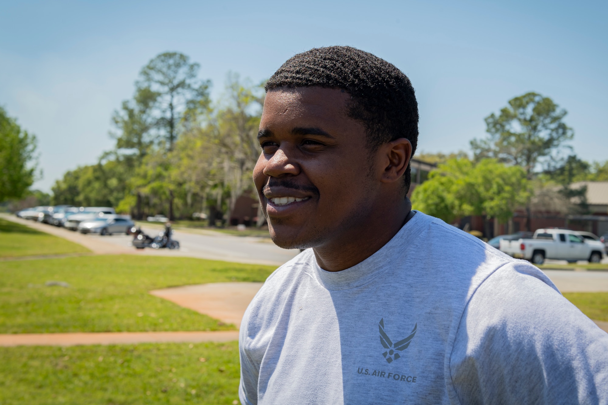 Photo of an Airman smiling before a kickball tournament