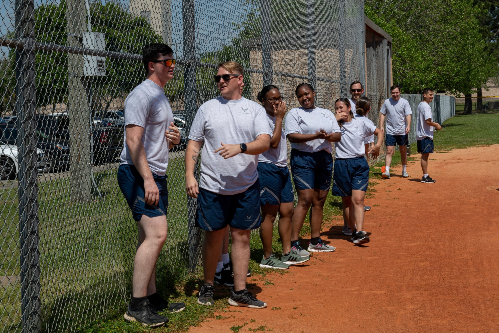 Photo of Airmen laughing during a kickball tournament