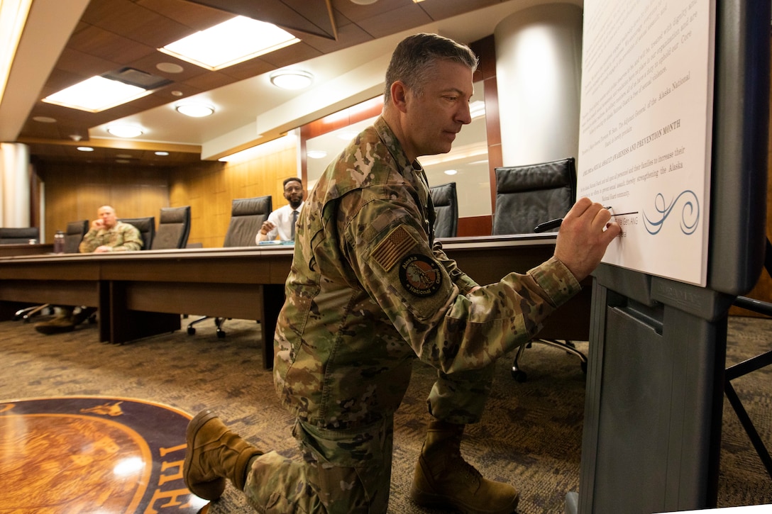 Maj. Gen. Torrence Saxe, adjutant general and commissioner for the Department of Military and Veterans Affairs, signs a proclamation for Sexual Assualt Awareness and Preventation Month on Joint Base Elmendorf-Richardson, March 30. The Alaska National Guard recognizes SAAPM as part of a Department of Defense-wide focus on raising awareness of sexual harassment and sexual assault, prevention methods, and appropriate care and responses. (U.S. Army National Guard photo by Victoria Granado)