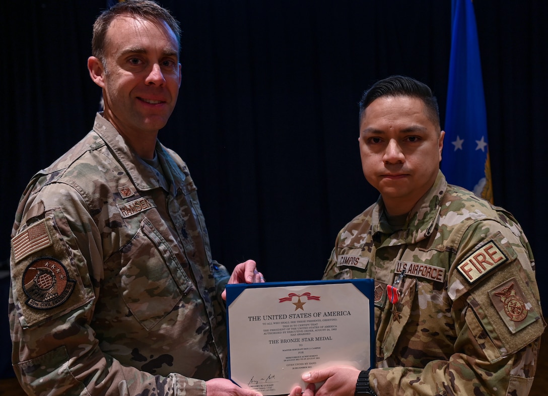 Lt. Col. Charles Hansen, 30th Civil Engineer Squadron commander, presents a Bronze Star Medal to MSgt. Roy Campos, 30th Civil Engineer Squadron readiness division chief on Vandenberg Space Force Base, Calif., March 31, 2022. Campos received this medal for his exemplary leadership and devotion to duty while under constant threat of enemy attacks, he and his team rescued and evacuated family members of 12 Afghan firefighters. (U.S. Space photo by Airman 1st Class Tiarra Sibley)