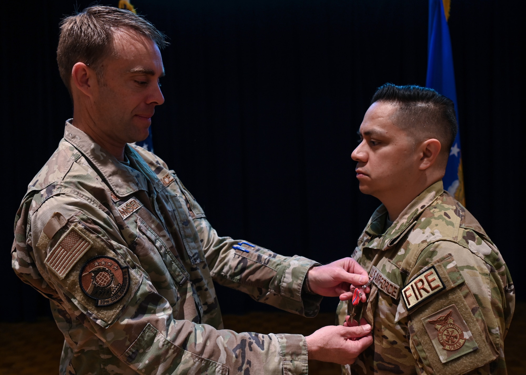 Lt. Col. Charles Hansen, 30th Civil Engineer Squadron commander, presents a Bronze Star Medal to MSgt. Roy Campos, 30th Civil Engineer Squadron readiness division chief on Vandenberg Space Force Base, Calif., March 31, 2022. Campos directed immediate action that moved his team into defensive fighting positions to maintain perimeter security for over eight hours, and directed 22 emergency responses with one of them being outside the controlled perimeter while exposed to enemy forces. (U.S. Space photo by Airman 1st Class Tiarra Sibley)