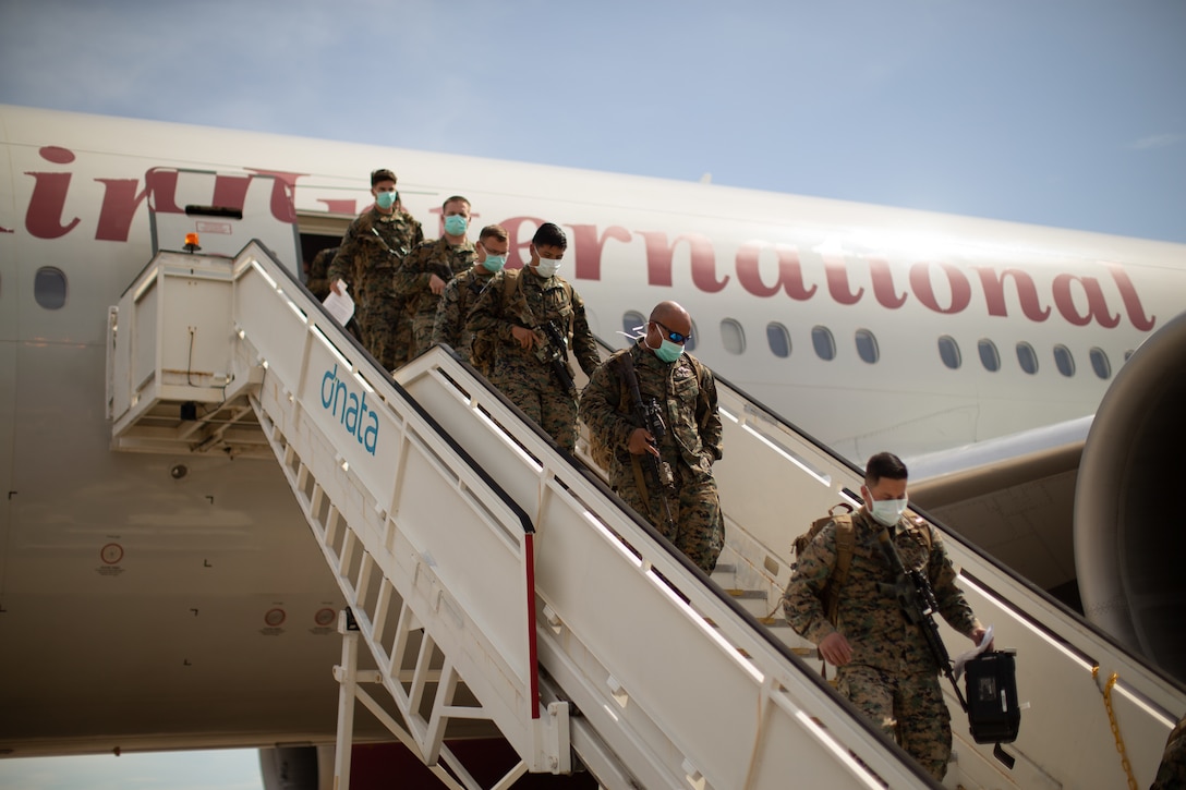 U.S. Marines with the Command Element, 5th Marine Regiment, Marine Rotational Force Darwin (MRF-D) 22 offload a Boeing 777 at Royal Australian Air Force Base Darwin, NT, Australia, March 12, 2022. MRF-D 22 is a six month rotation where U.S. Marines, the Australian Defence Force, and other allied and partner nations enhance their interoperability and readiness posture in the Indo-Pacific region. (U.S. Marine Corps Photo by Cpl. Cedar Barnes)