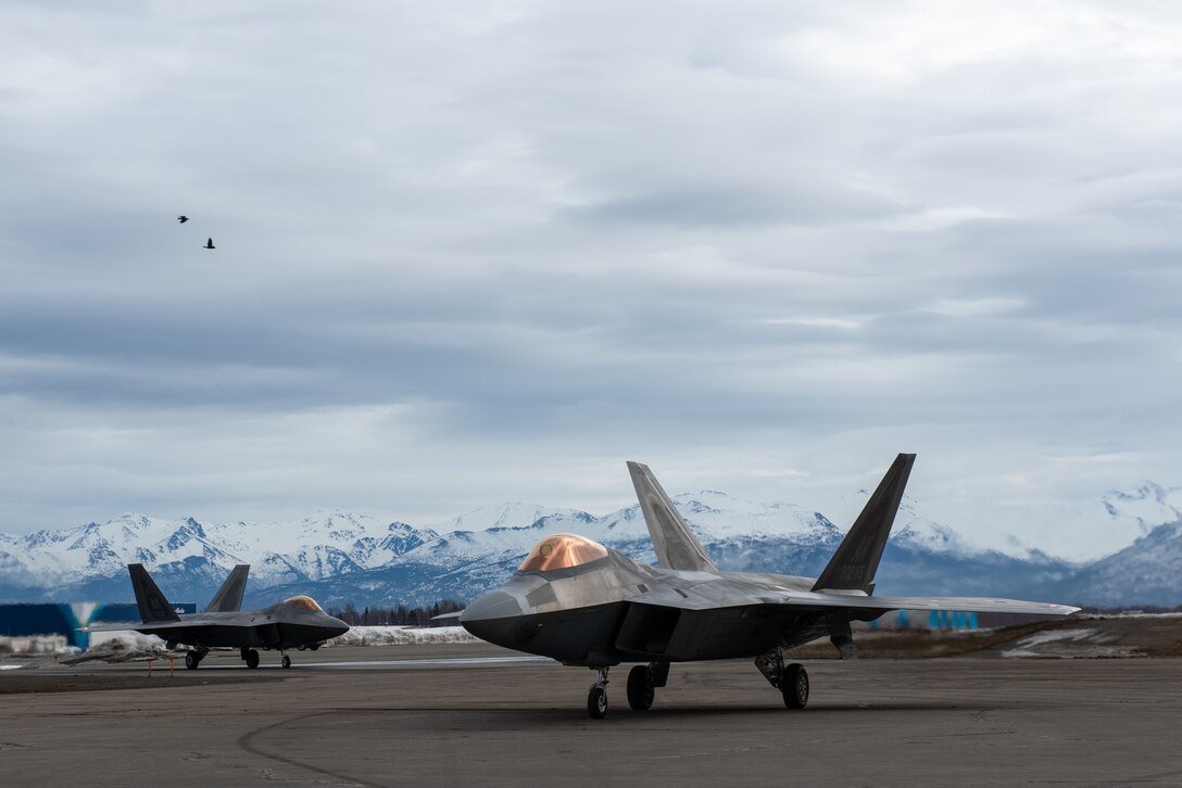 A photo of F-22 Raptor aircraft taxing to a recovery point.
