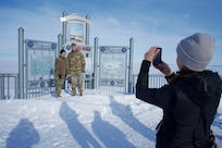 JOINT BASE ELMENDORF-RICHARDSON, Alaska -- Azara Mohammadi, Alaska National Guard tribal liaison, photographs Brig. Gen. Jackie Huber and Col. Brock Larson National Guard Arctic Interest Council delegates representing the North Dakota National Guard March 29, 2022, at the Kotzebue, Alaska, sea wall overlooking the frozen Chukchi Sea. The NG-AIC provides a forum of representatives and subject matter experts from States with Arctic interests, capabilities and resources. (Alaska National Guard photo by Capt. David Bedard)