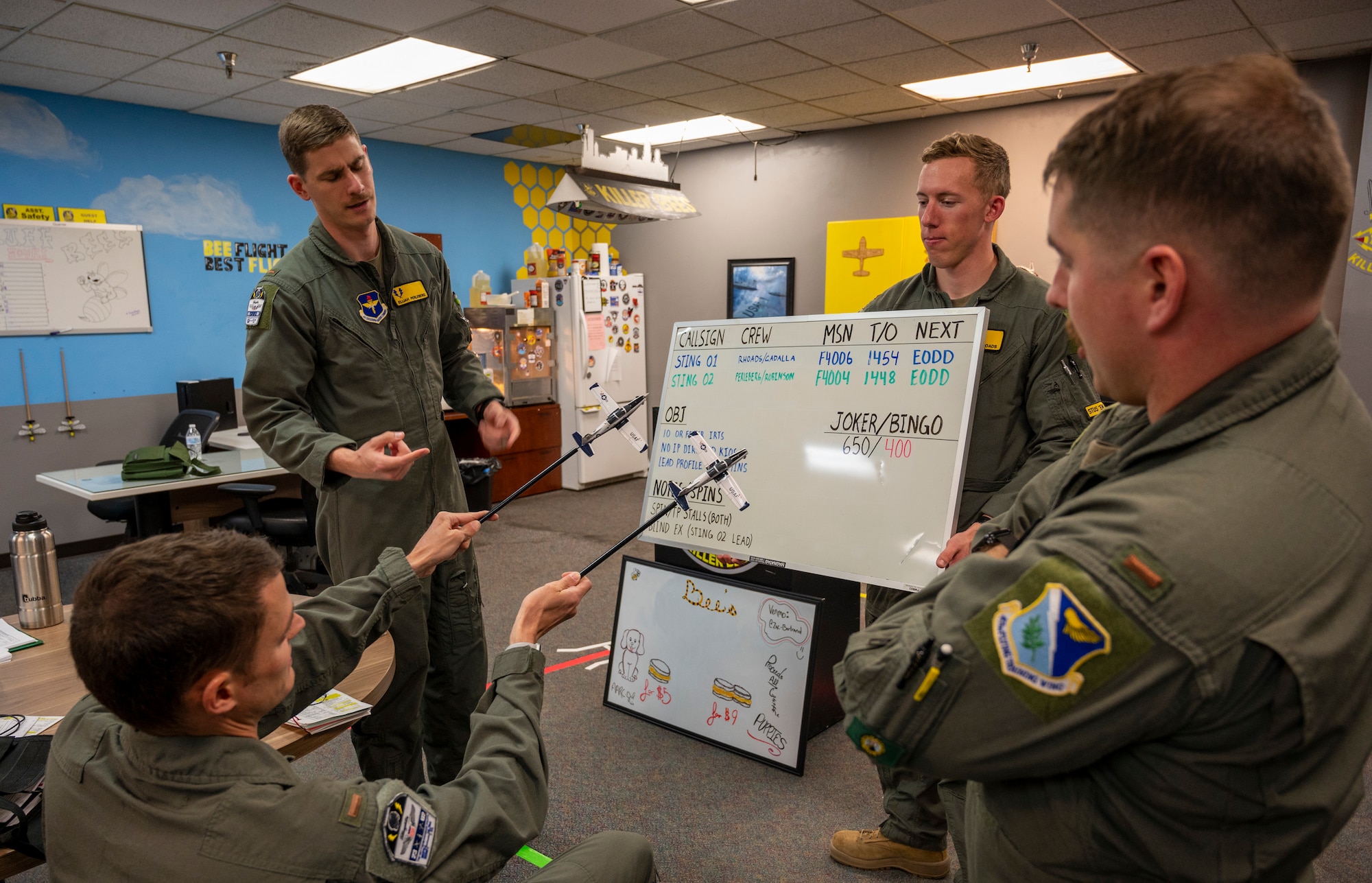 Students from the 85th Flying Training Squadron Bee Flight use model aircraft to simulate maneuvers in the classroom on March 30 2021 at Laughlin Air Force Base, Texas. The model aircraft help student pilots get a 3rd person view and idea of how the planes will work. (U.S. Air Force photo by Senior Airman Nicholas Larsen)