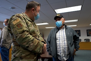 JOINT BASE ELMENDORF-RICHARDSON, Alaska -- Vietnam War veteran Walter Sampson speaks with Air National Guard Chief Master Sgt. Clinton Miller, National Guard Bureau, at a potluck in Kotzebue, Alaska, following a March 29, 2022, National Guard Arctic Interest Council meeting there. The council met in the arctic community to understand issues facing communities in the region. (Alaska National Guard photo by Capt. David Bedard)