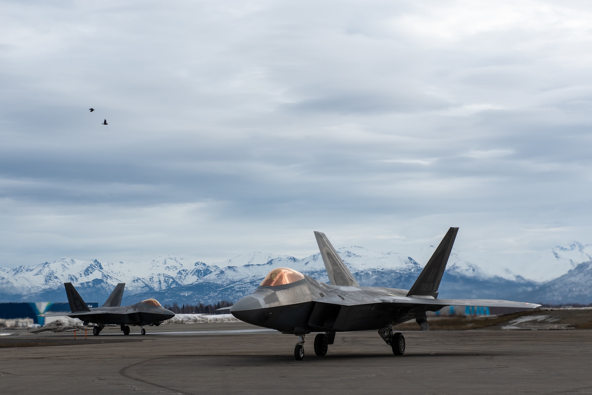A photo of F-22 Raptor aircraft taxing to a recovery point.