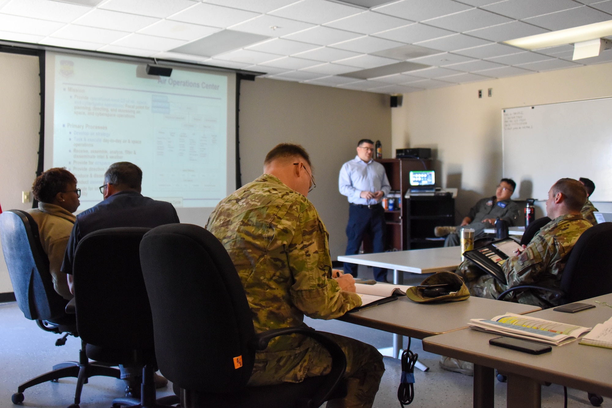 A photo of an Airman recording notes.