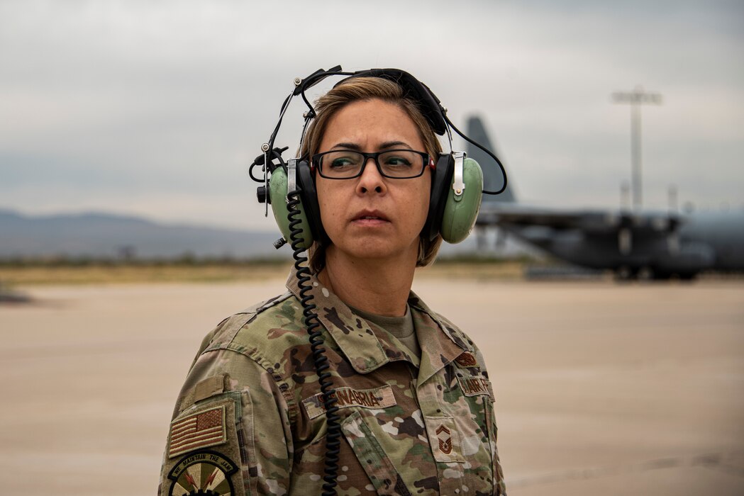 A photo of a female pilot in front of an EC-130H Compass Call.