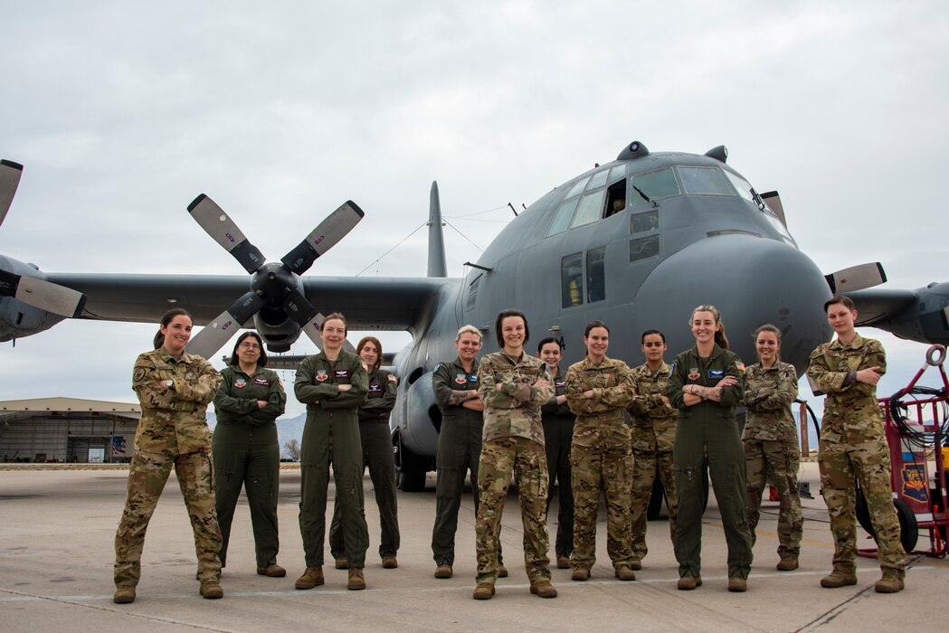A group photo of female Airmen in front of an EC-130H Compass call.