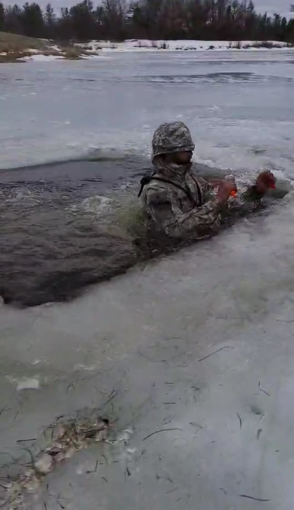 Senior Airman Muhammad-Alamin Qubaisy, 174th Attack Wing Security Forces member, participated in a three-week Cold Weather Operations Course at Fort McCoy, WI. One of the training obstacles was called cold-water immersion. Instructors cut a hole into a nearby frozen lake and the students learn how to effectively get back on the ice. The training teaches members how to become adapt, operate and survive in extreme weather. (Courtesy photo)