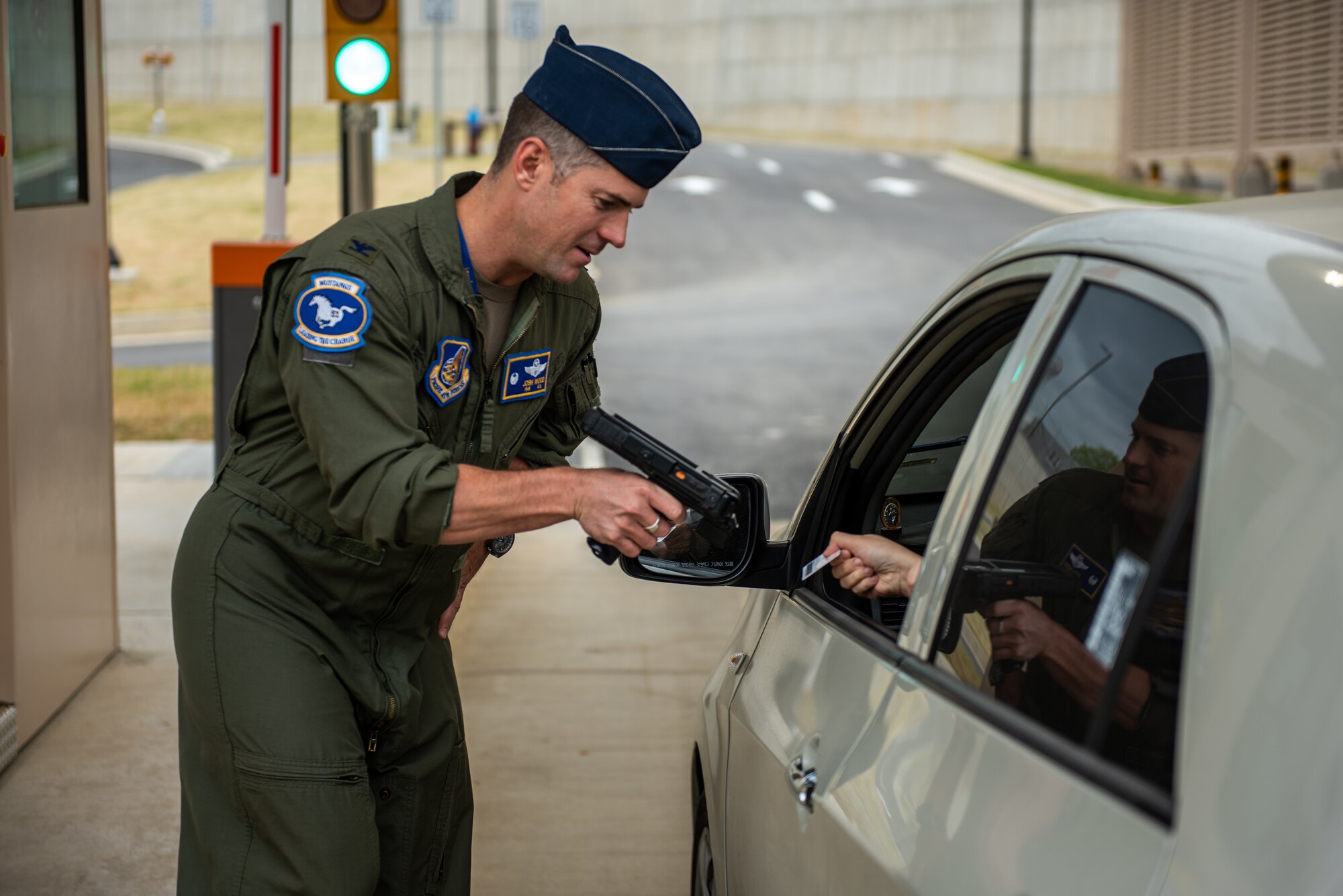Col. Joshua Wood, 51st Fighter Wing commander, scans a base guest’s identification card after the opening of the new main gate, April 29, 2022 at Osan Air Base, Republic of Korea.