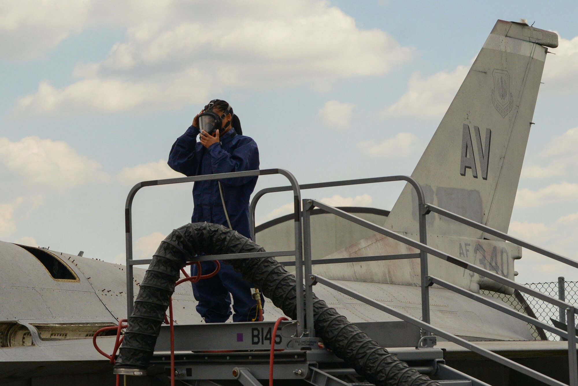 Airman 1st Class Jada Spencer, 31st Maintenance Squadron aircraft fuel systems technician, puts on a gas mask during an exercise