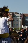 A young Louisville, Ky., native salutes the 2nd Marine Aircraft Wing Band as they pass by during the 2022 Pegasus Parade.  The band out of Marine Corps Air Station Cherry Point, N.C., performed for hundreds of thousands of people along the parade route that was also broadcast to millions across the country.  Performances like these strengthen relationships between the community and the Marine Corps while increasing awareness about opportunities for service in the Marine Corps.