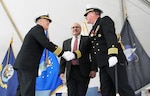IMAGE: Capt. Philip Mlynarski, left, incoming commanding officer of Naval Surface Warfare Center Dahlgren Division (NSWCDD), shakes hands with Capt. Stephen "Casey" Plew, outgoing commanding officer of NSWCDD, as Mark Oesterreich, Naval Surface/Undersea Warfare Centers Headquarters Chief of Staff looks on during a change of command ceremony at the Potomac River Test Range, April 29.