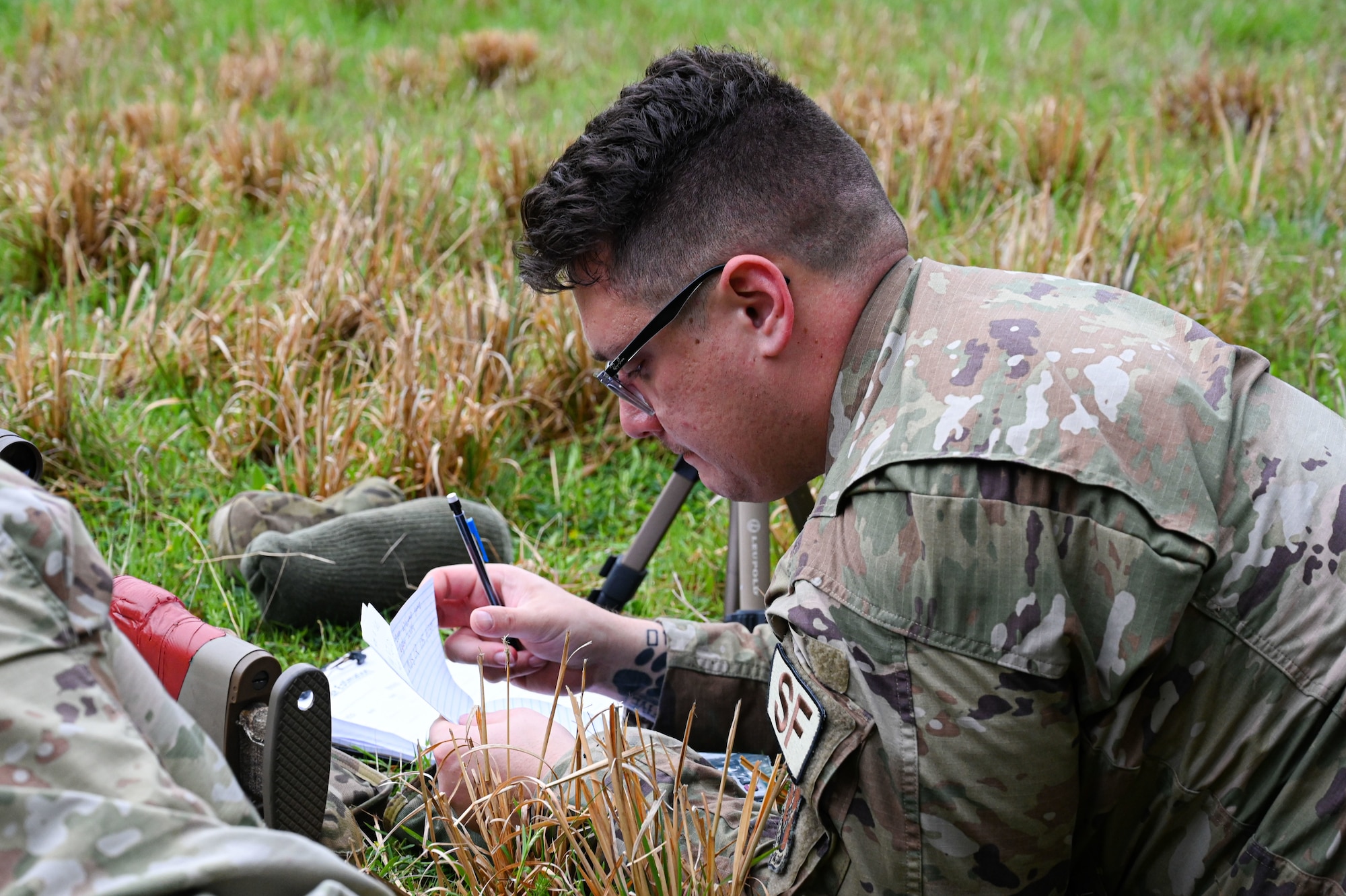 An Airman from the 19th Security Forces Squadron makes corrections to a range card during an Advanced Designated Marksman course