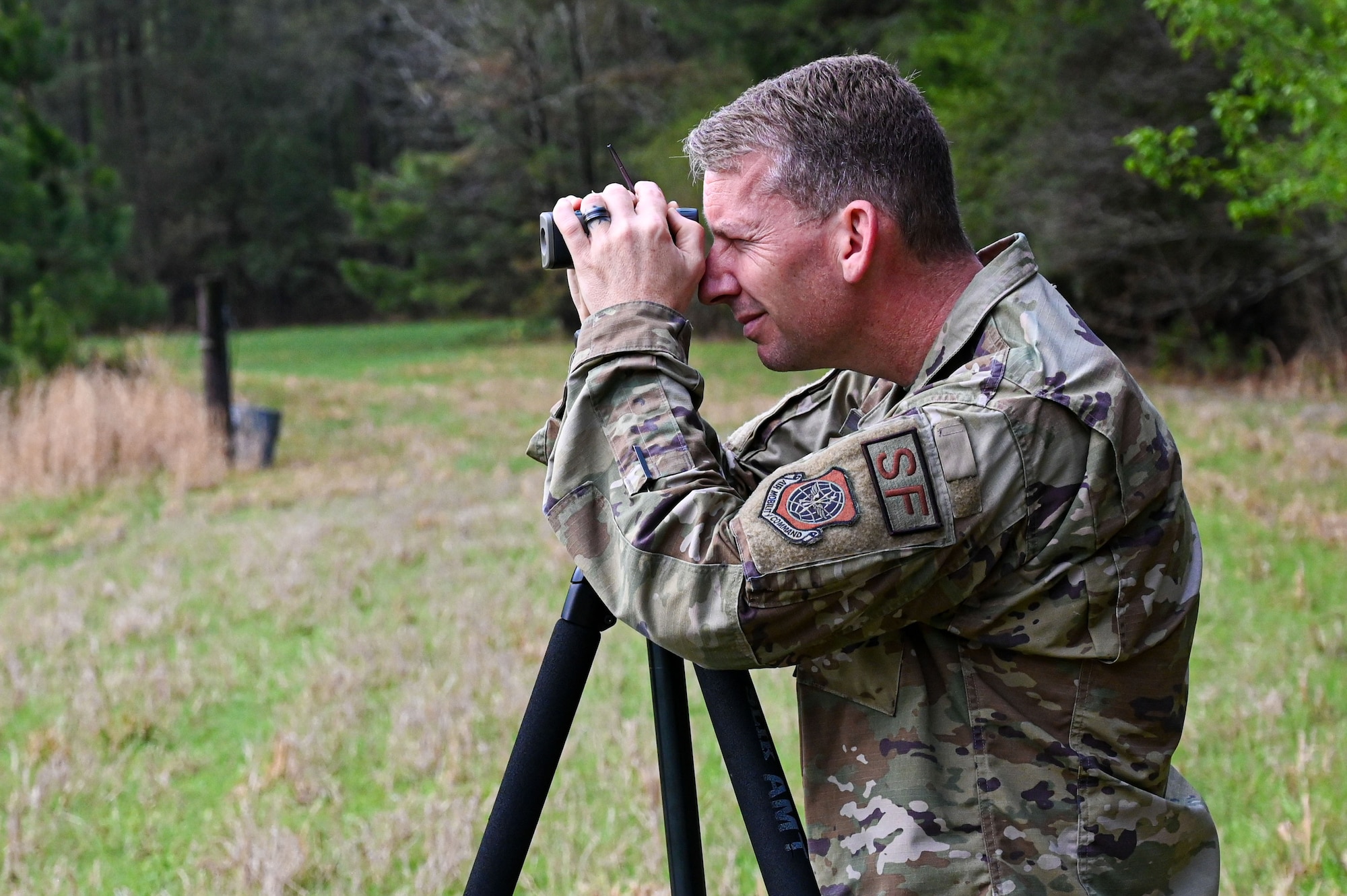 An Airman from the 19th Security Forces Squadron checks targets through a scope during an Advanced Designated Marksman course