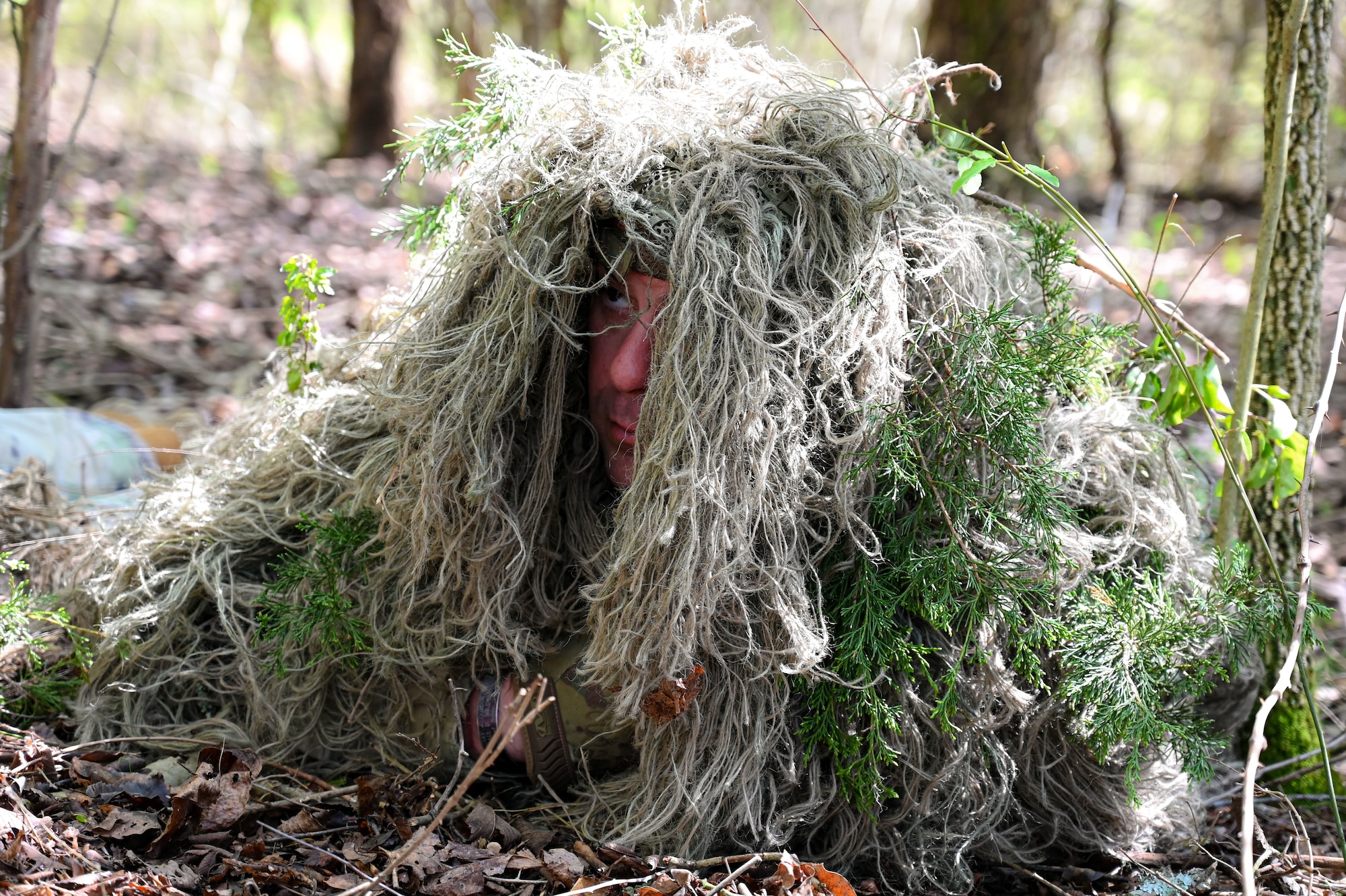 An Airman from the 19th Security Forces Squadron conceals himself during an Advanced Designated Marksman course