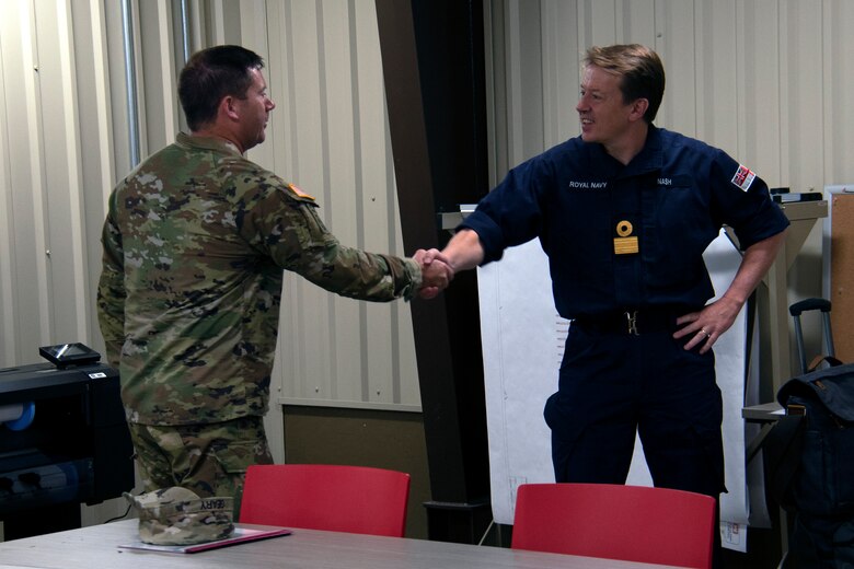 SAVANNAH, Ga. – Col. Joseph Geary, Savannah District commander, left, greets Royal Navy Commodore Philip Nash at the U.S. Army Corps of Engineers, Savannah District in Savannah, Georgia on April 28. Nash, who is the Royal Naval attaché to the U.S. at the British Embassy in Washington D.C., visited the Corps to view the 19 cannon and various other artifacts that the Corps recently recovered in the Savannah River during its Savannah Harbor Expansion Project. USACE photo by Mel Orr.