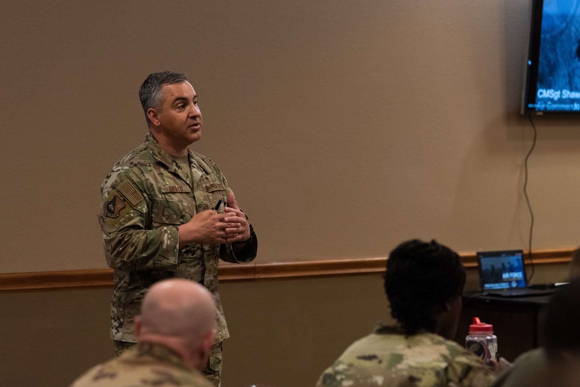 Chief Master Sgt. Aiello speaks to a group of Airmen and Guardians.