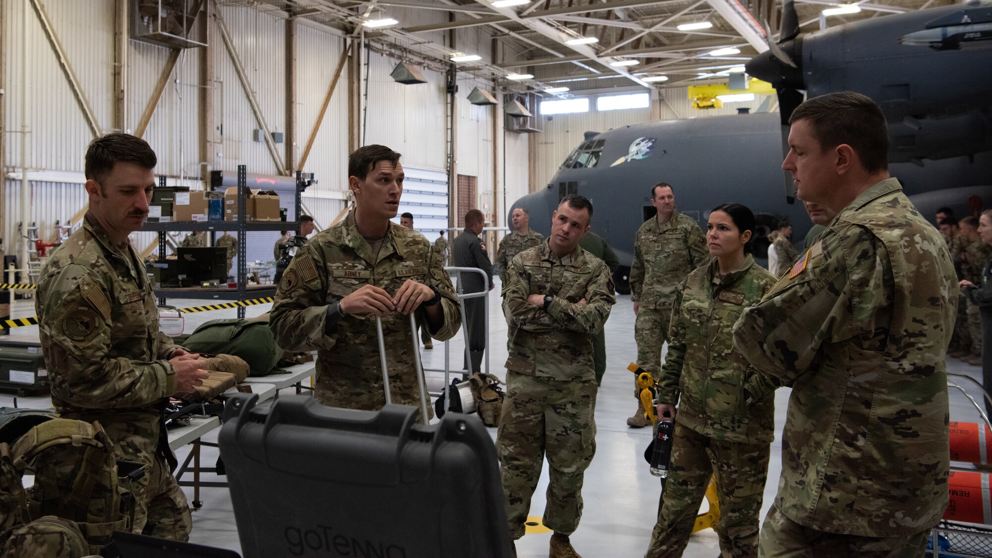 Airmen and Guardians are listening to another Airmen explain their display.
