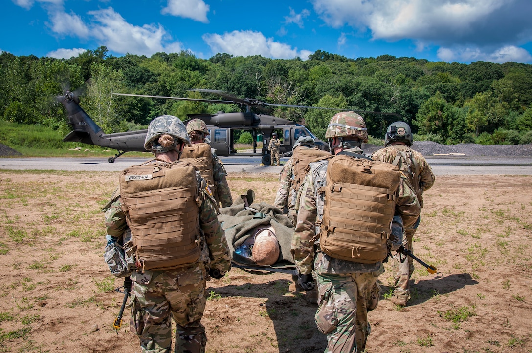Students in the Connecticut National Guard's 169th Regiment, Regional Training Institute, Combat Medic reclassification course transport a simulated casualty to a Blackhawk helicopter during a field training exercise at Stones Ranch Military Reservation, East Lyme, Conn. Aug. 18, 2020.