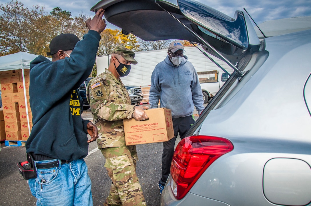 U.S. Army Staff Sgt. Evan Nava, a recruiter for the Connecticut National Guard, loads a box of food into a car at a drive-through food distribution point for the Farmers to Families Program in New Haven, Conn. Oct. 27, 2020. This ongoing mission is just one of the many ways our Guardsmen continues to serve their communities during the COVID-19 Pandemic.