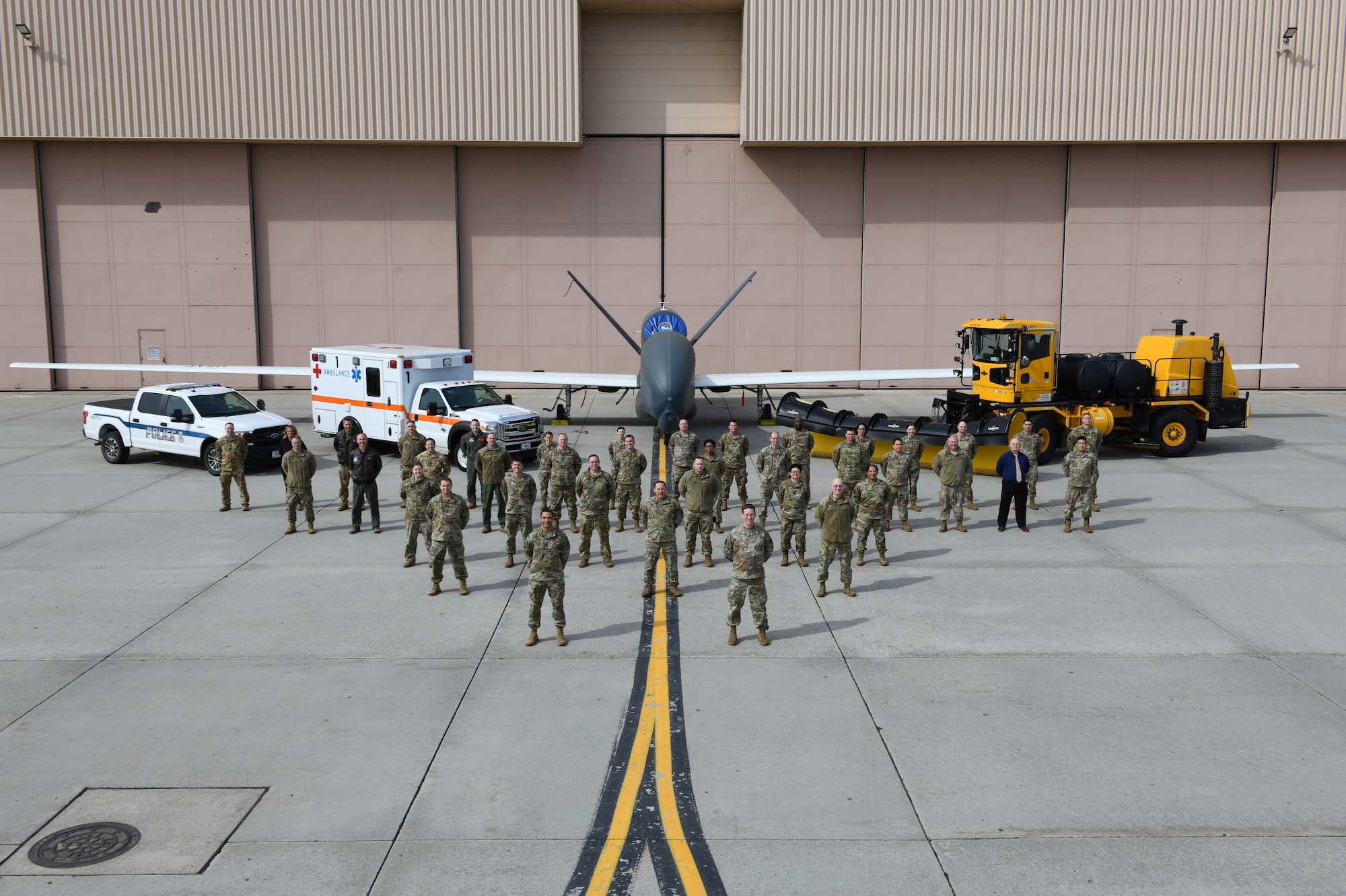 Leaders across the 319th Reconnaissance Wing stand for a group photo during the Wing Leadership Summit on the flight line, Grand Forks Air Force Base, North Dakota, April 21, 2022. The purpose of the annual summit is for leaders to meet and discuss how each organization, including geographically separated units, align with the wing’s strategic plan and higher headquarters priorities. (U.S. Air Force Photo by Senior Airman Ashley Richards)